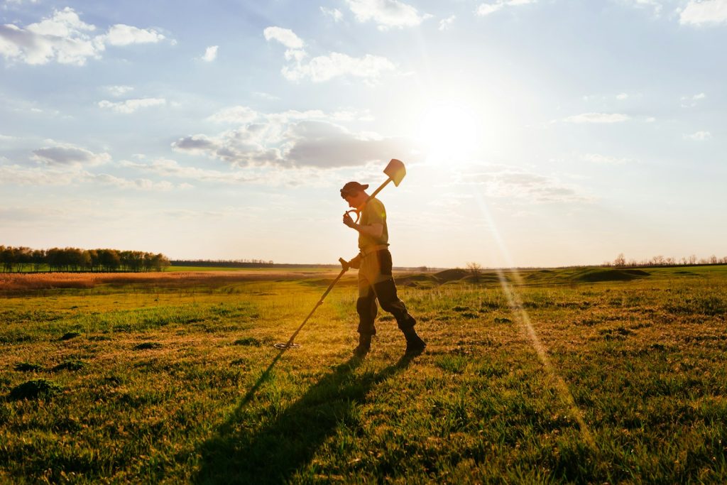 a man holding a ball and walking in a field